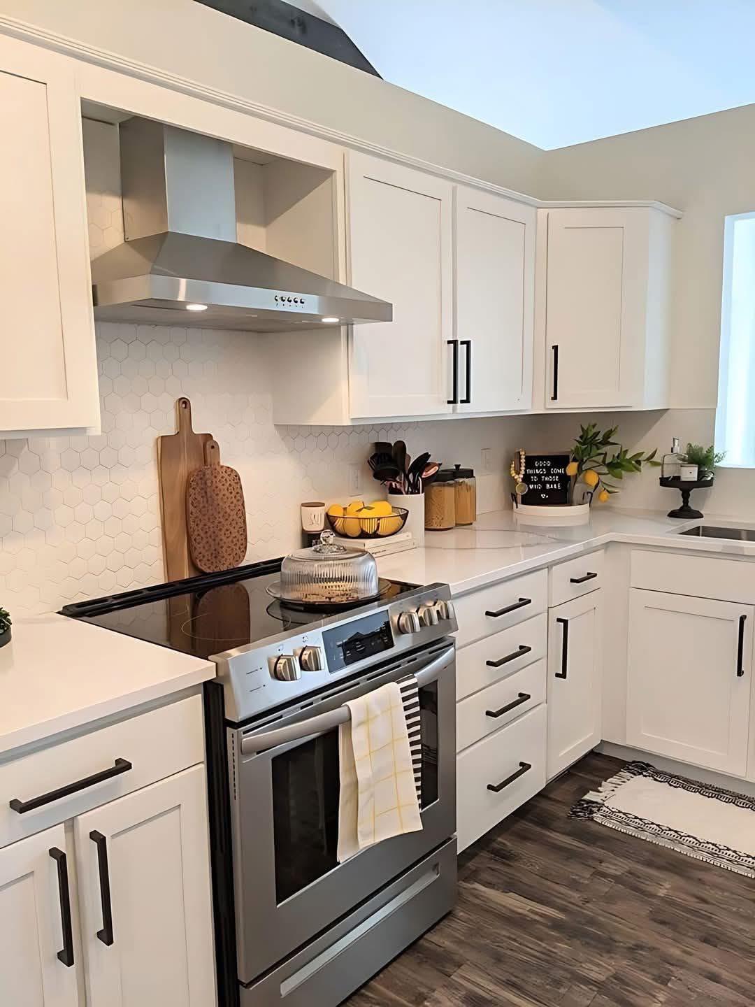 Bright white kitchen with spotless counters and stainless range after cleaning