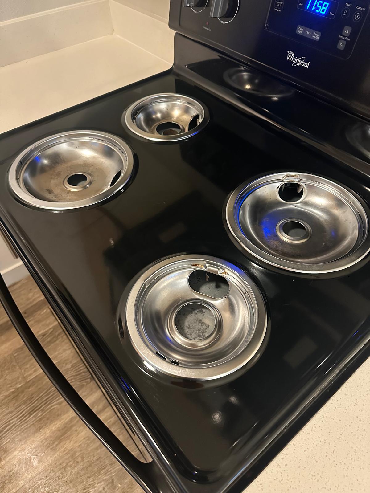 Before: Burner drip pans — stained — Keep Clean Solutions LLC